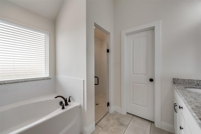 full bath with plenty of natural light, a garden tub, vanity, and a stall shower