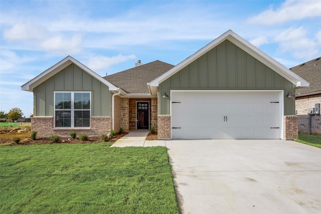 view of front facade with concrete driveway, board and batten siding, an attached garage, a front yard, and brick siding