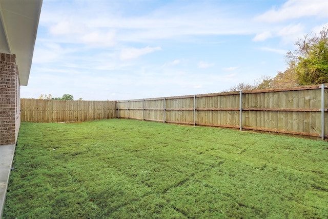 view of yard with a fenced backyard