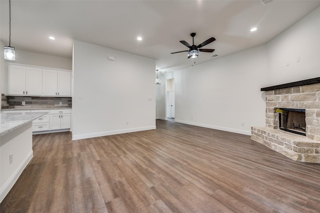unfurnished living room with recessed lighting, wood finished floors, a fireplace, and ceiling fan