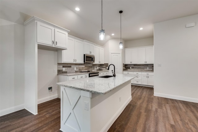 kitchen with dark wood finished floors, a sink, stainless steel microwave, and electric range