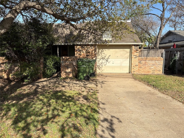 garage with driveway and fence
