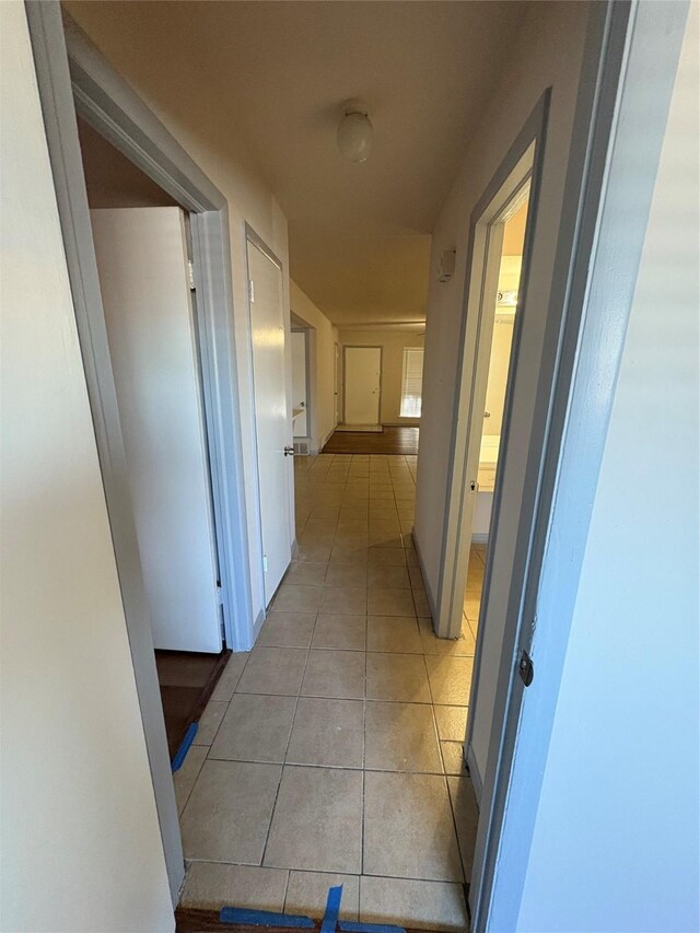 corridor featuring light tile patterned floors