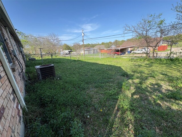 view of yard featuring cooling unit and fence