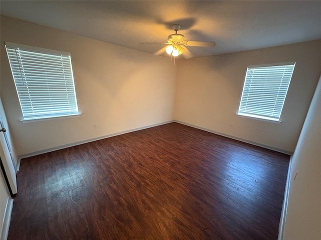 unfurnished room featuring baseboards, wood finished floors, and ceiling fan