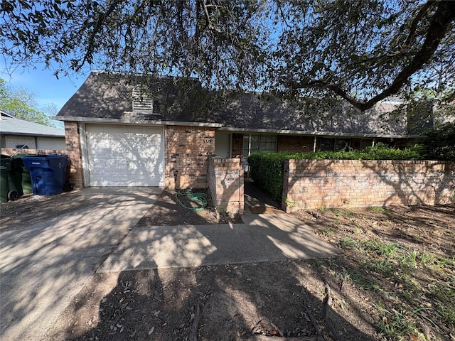 view of front of home with an attached garage, brick siding, and concrete driveway