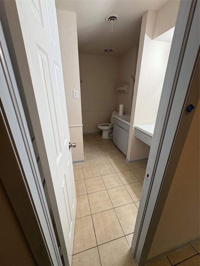 bathroom featuring vanity, toilet, tile patterned flooring, and visible vents