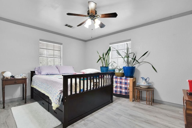 bedroom featuring baseboards, visible vents, and crown molding