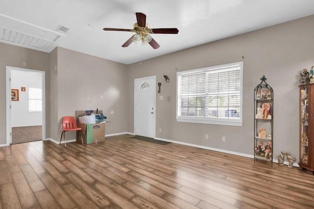 entrance foyer featuring wood finished floors, visible vents, a ceiling fan, and baseboards