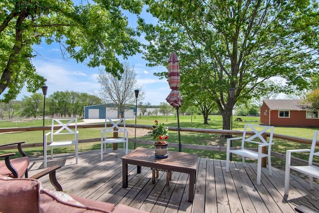 deck with a lawn and an outdoor structure