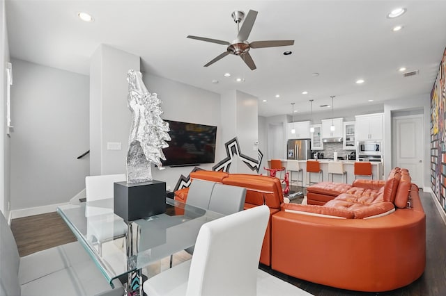 living area with a ceiling fan, stairs, baseboards, visible vents, and recessed lighting