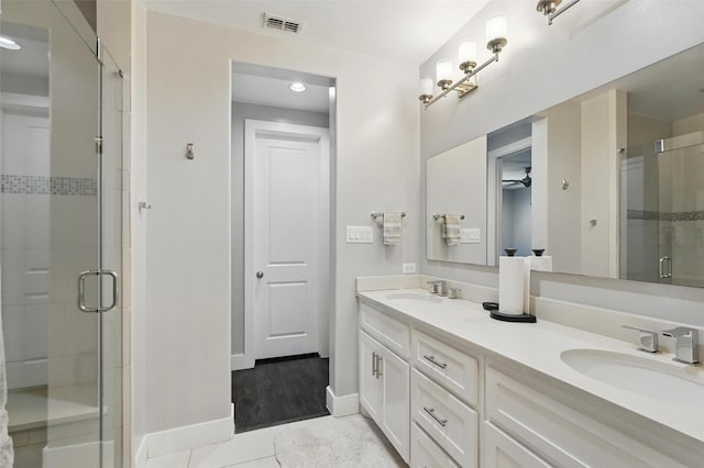 bathroom featuring a shower stall, visible vents, a ceiling fan, and a sink
