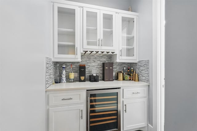bar with backsplash, beverage cooler, and a dry bar