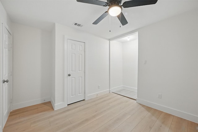 unfurnished bedroom with light wood-style flooring, visible vents, and baseboards