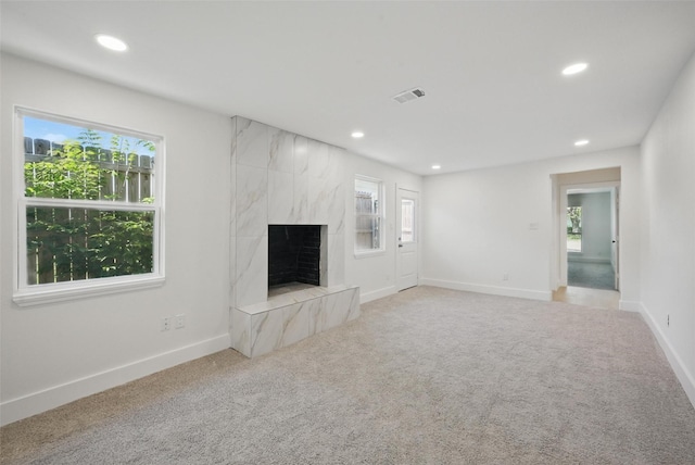 unfurnished living room featuring a wealth of natural light, visible vents, and recessed lighting