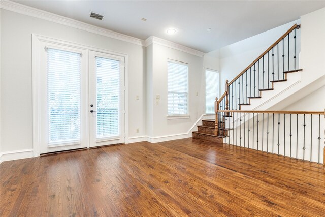 foyer entrance with visible vents, ornamental molding, stairs, and french doors