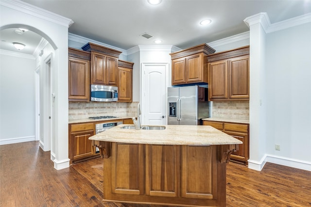 kitchen with a sink, baseboards, stainless steel appliances, and dark wood-type flooring