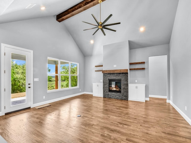 117 Fan Mill Trl, Weatherford, TX 76085 - unfurnished living room with wood finished floors, a healthy amount of sunlight, a ceiling fan, and high vaulted ceiling