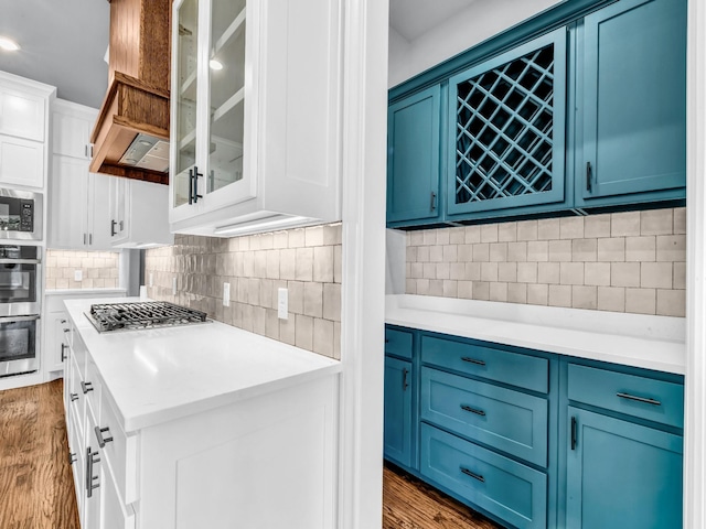 117 Fan Mill Trl, Weatherford, TX 76085 - kitchen with blue cabinets, light countertops, and dark wood-style flooring