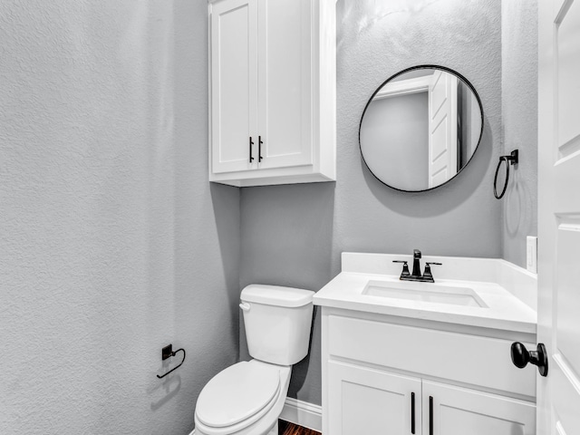 117 Fan Mill Trl, Weatherford, TX 76085 - half bathroom with a textured wall, wood finished floors, vanity, and toilet