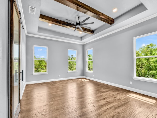 117 Fan Mill Trl, Weatherford, TX 76085 - empty room with wood finished floors, visible vents, a raised ceiling, and a healthy amount of sunlight