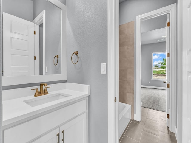 117 Fan Mill Trl, Weatherford, TX 76085 - full bath with tile patterned floors, a textured wall, shower / bathtub combination, vanity, and baseboards