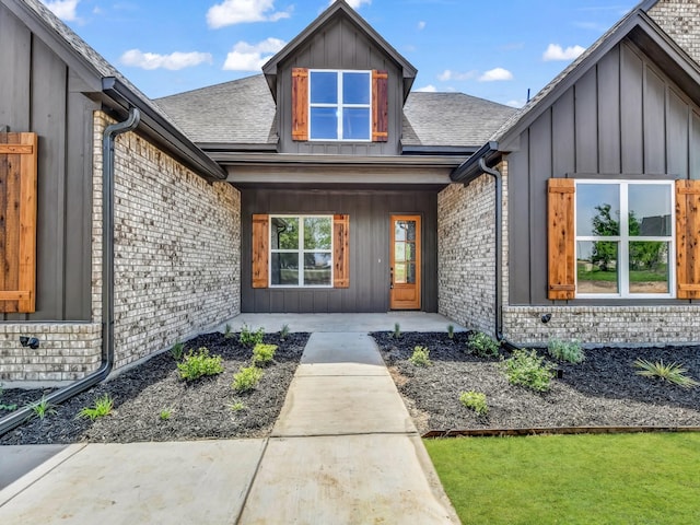 117 Fan Mill Trl, Weatherford, TX 76085 - doorway to property featuring brick siding, roof with shingles, board and batten siding, and covered porch
