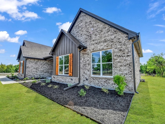 117 Fan Mill Trl, Weatherford, TX 76085 - view of home's exterior featuring board and batten siding, a lawn, and brick siding