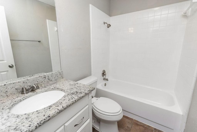 bathroom with washtub / shower combination, vanity, and toilet