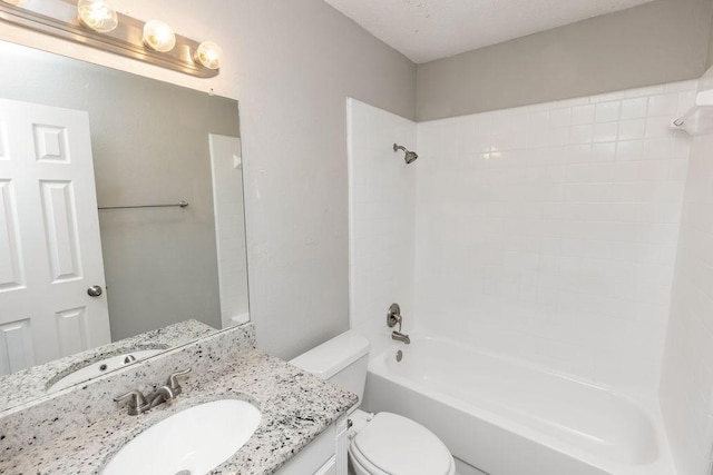 bathroom with toilet, vanity, and washtub / shower combination