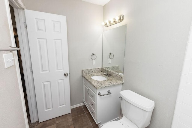 bathroom with tile patterned floors, vanity, and toilet