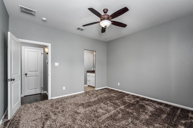 unfurnished bedroom with carpet floors, visible vents, baseboards, and connected bathroom