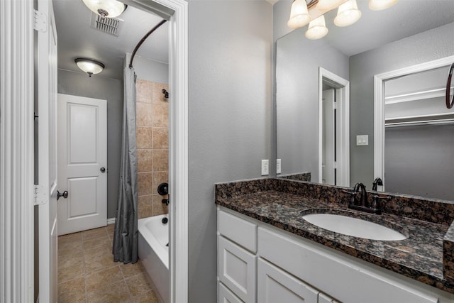 bathroom with shower / tub combo with curtain, vanity, tile patterned floors, and visible vents