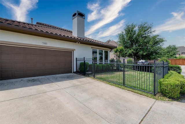 mediterranean / spanish-style house featuring fence, stucco siding, a tile roof, driveway, and a front yard