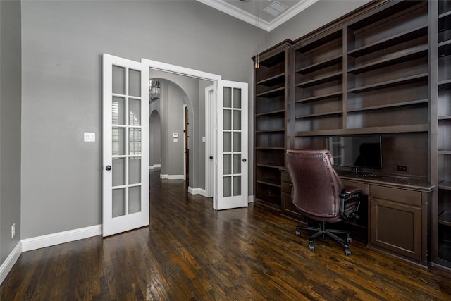 unfurnished office featuring dark wood-style flooring, arched walkways, french doors, baseboards, and ornamental molding