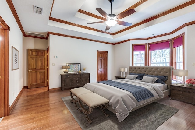 516 Wild Wood Dr, Decatur, TX 76234 - bedroom with a raised ceiling, light wood-type flooring, crown molding, and ceiling fan
