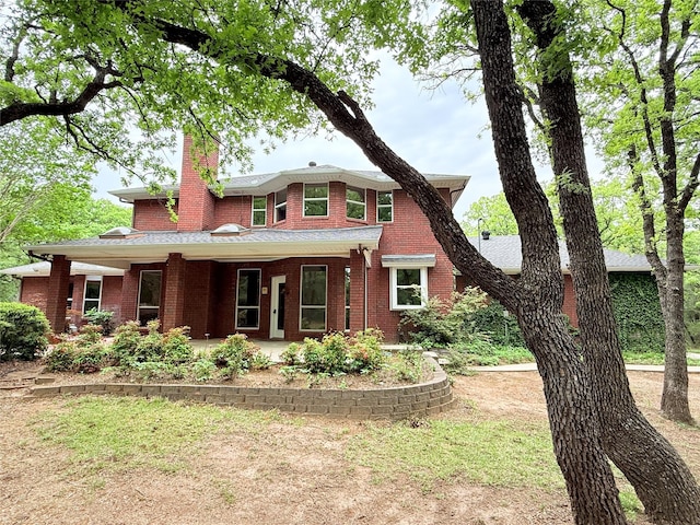 516 Wild Wood Dr, Decatur, TX 76234 - view of front facade with a chimney, brick siding, and a porch
