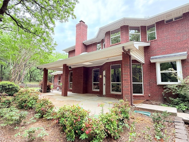 516 Wild Wood Dr, Decatur, TX 76234 - back of property featuring a chimney and brick siding
