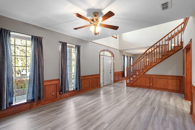 516 Wild Wood Dr, Decatur, TX 76234 - entryway with wainscoting, stairs, light wood-style floors, and ceiling fan