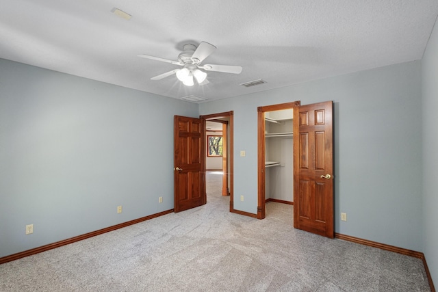 516 Wild Wood Dr, Decatur, TX 76234 - unfurnished bedroom featuring carpet flooring, a walk in closet, a closet, and a ceiling fan