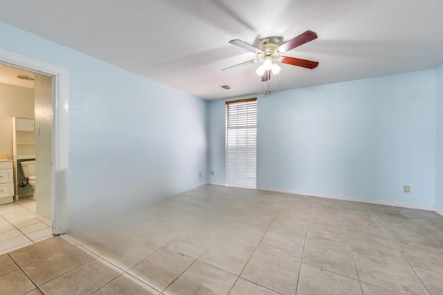 spare room with ceiling fan, visible vents, and light tile patterned floors