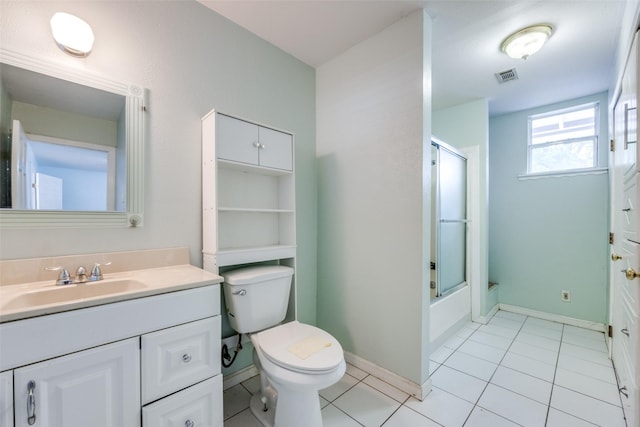 bathroom featuring tile patterned floors, shower / bath combination with glass door, toilet, visible vents, and vanity
