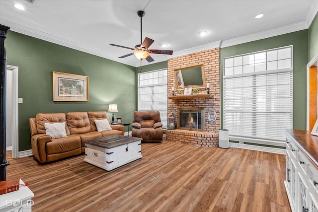 5021 Kenilworth Dr, Bossier City, LA 71112 - living room featuring light wood-style flooring, crown molding, ceiling fan, a fireplace, and recessed lighting