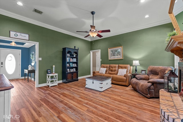 5021 Kenilworth Dr, Bossier City, LA 71112 - living area featuring light wood finished floors, a ceiling fan, a fireplace, crown molding, and baseboards