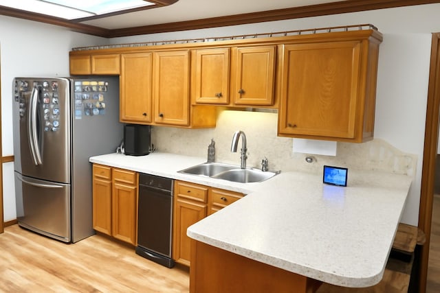 5021 Kenilworth Dr, Bossier City, LA 71112 - kitchen with freestanding refrigerator, a sink, a peninsula, light countertops, and light wood-type flooring