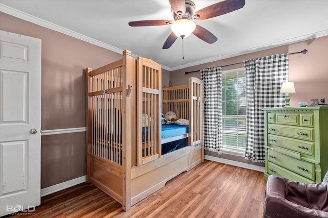 5021 Kenilworth Dr, Bossier City, LA 71112 - bedroom featuring baseboards, wood finished floors, crown molding, and a ceiling fan