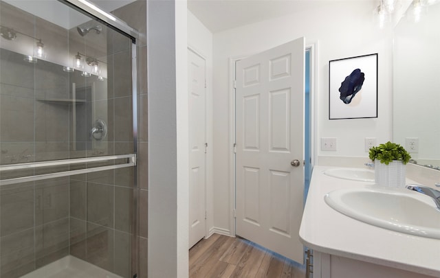 14151 Maida Dr, Pilot Point, TX 76258 - bathroom featuring double vanity, wood finished floors, a stall shower, and a sink