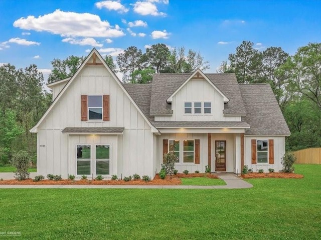 modern inspired farmhouse featuring board and batten siding, roof with shingles, a front yard, and fence