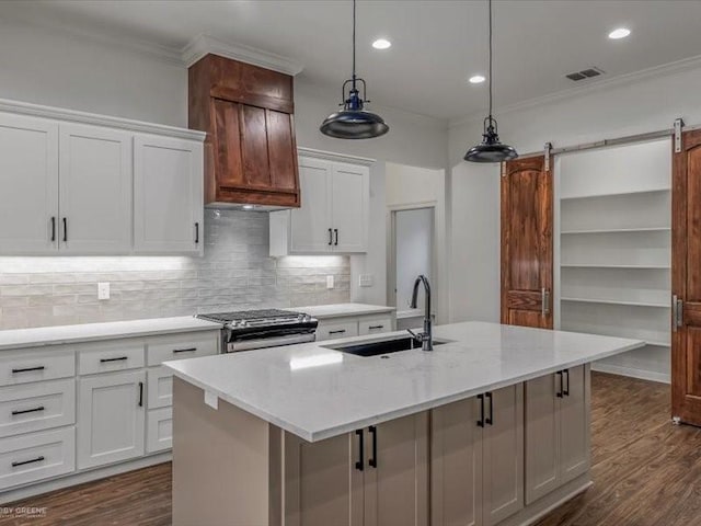 kitchen with stainless steel range with gas cooktop, visible vents, ornamental molding, and a sink
