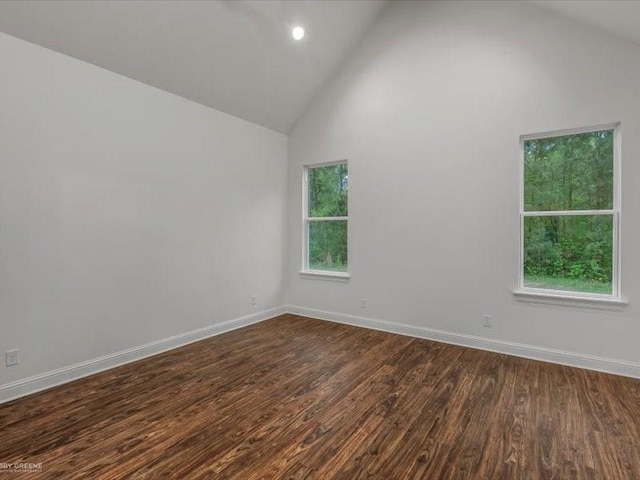 spare room with high vaulted ceiling, baseboards, recessed lighting, and dark wood-style floors